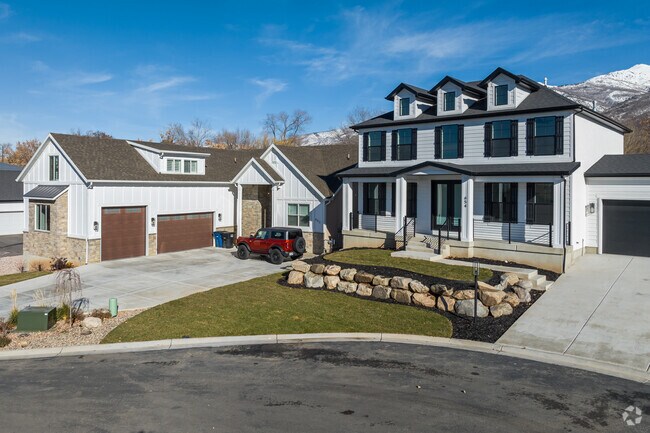 Large custom homes on this street in Fruit Heights have moderate yards.
