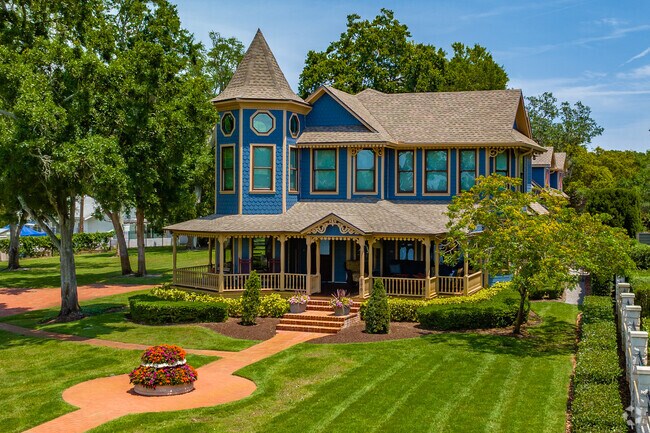 This Victorian style has a beautifully manicured lawn and lush landscaping.
