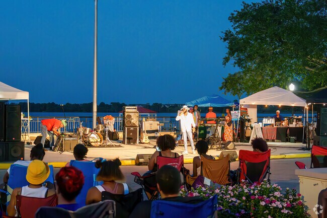 Baldwin Park residents bring chairs and gather at Harbor Park for Reggae Night.