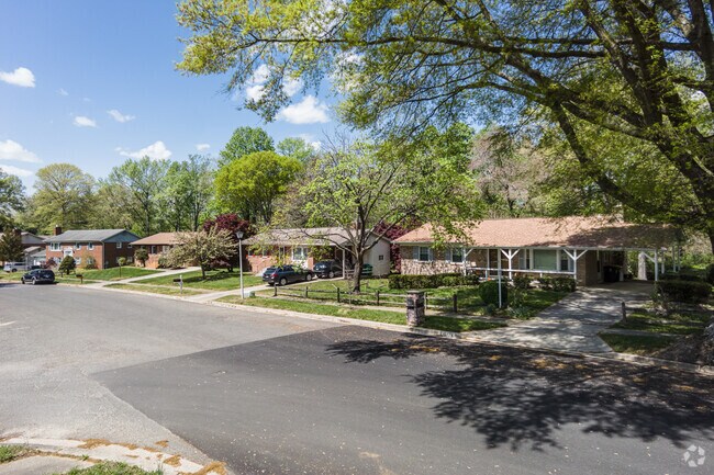 Ranch-style homes are shaded by mature trees in Rosaryville, Maryland.