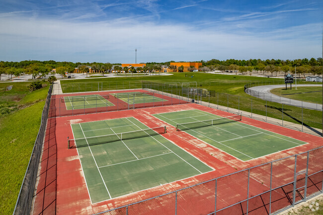Student grab a competitive game of tennis on the courts at West Port High School.