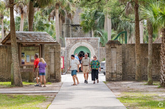 Visitors explore Atalaya Castle’s history at Huntington Beach State Park near Litchfield Beach.
