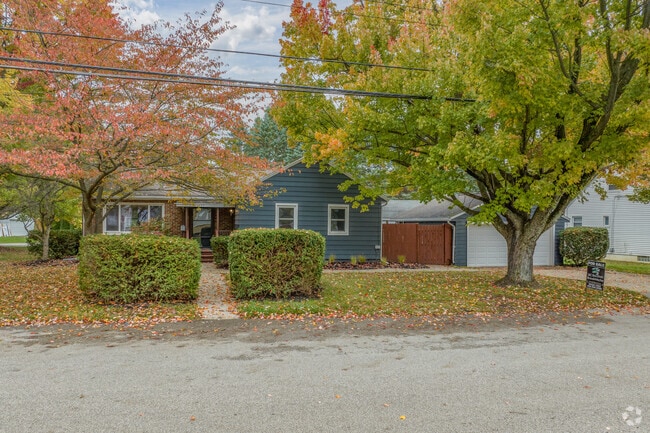 Brick Ranch style home with a tidy lawn in Johnsons Corners.