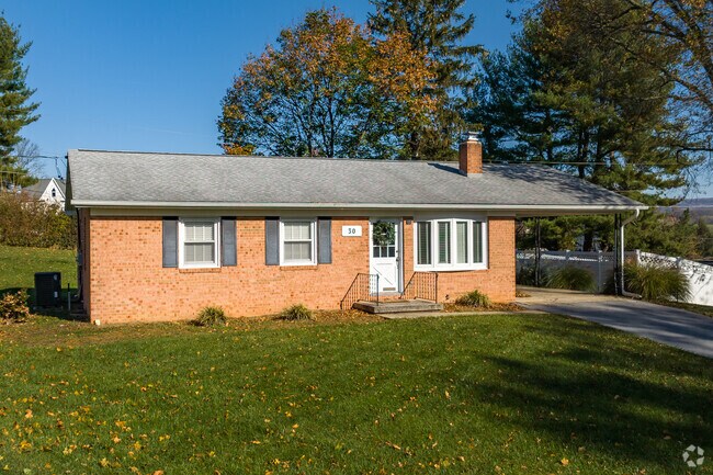 Modest brick rancher with a carport and ample yard space in Myersville.