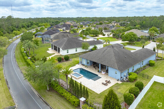 A private pool and vast curb appeal are notable features of this Breakaway Trails home.
