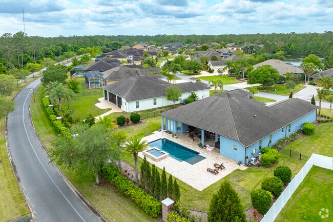 A private pool and vast curb appeal are notable features of this Breakaway Trails home.