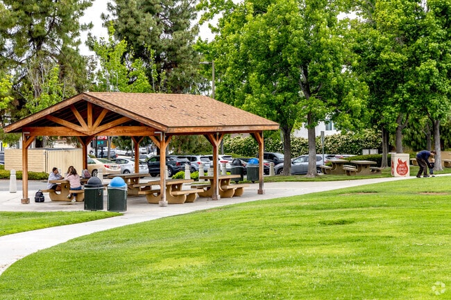 Covered picnic tables at Alamosa Park offer shade for family gatherings.