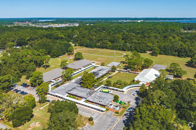 Hollingers Island Elementary School is surrounded by woods and greenery.