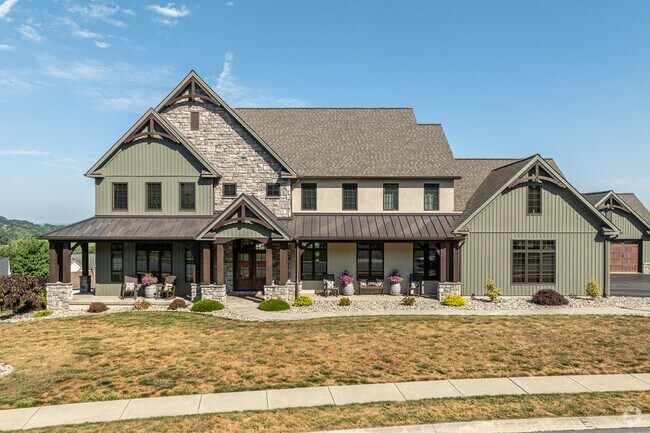 A large, mountain lodge-style home is located among other large homes in Oyster Point.