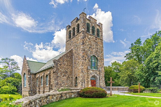 The iconic Stanhope United Methodist Church stands tall with rustic elegance, anchoring the community with spiritual heritage and architectural grace.