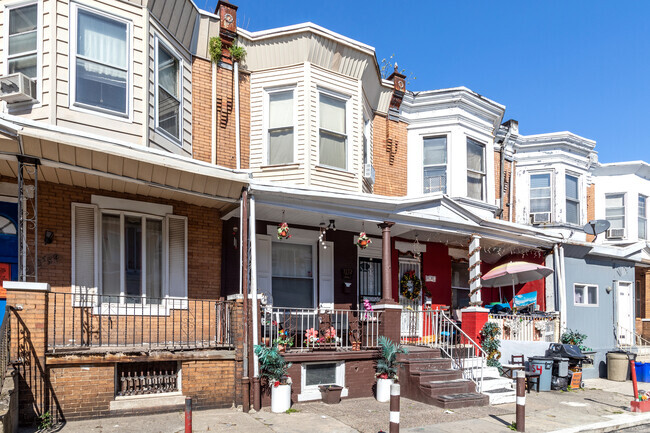 Two-story brick row house with Porch in the Allegheny West neighborhood.