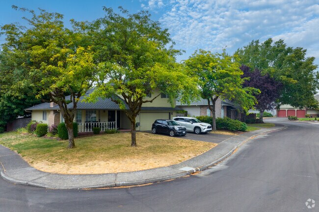 Mature trees line NE 160th Loop, framing Cimarron’s split-level homes.