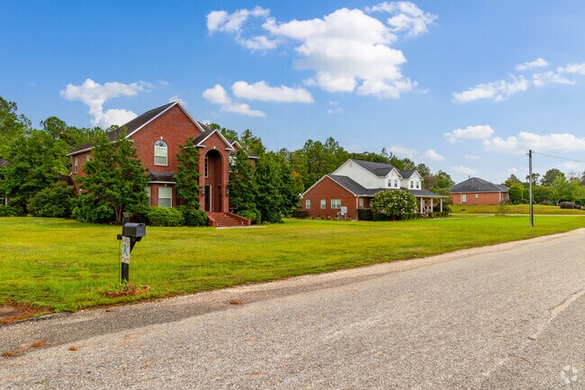Well-kept lawns and mature trees surround traditional houses in Monroeville’s residential neighborhoods.