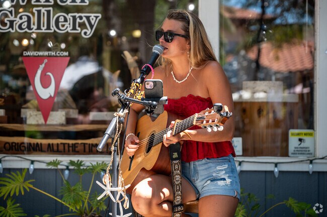 Local musicians play during the Christmas in July Market on nearby Canal Street.