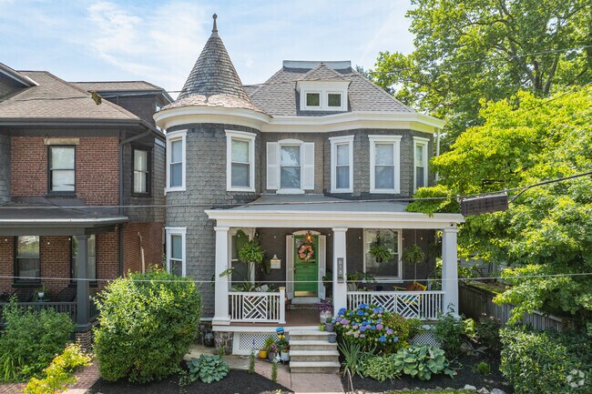 A beautiful Queen Anne style home with a round corner tower in Triangle.
