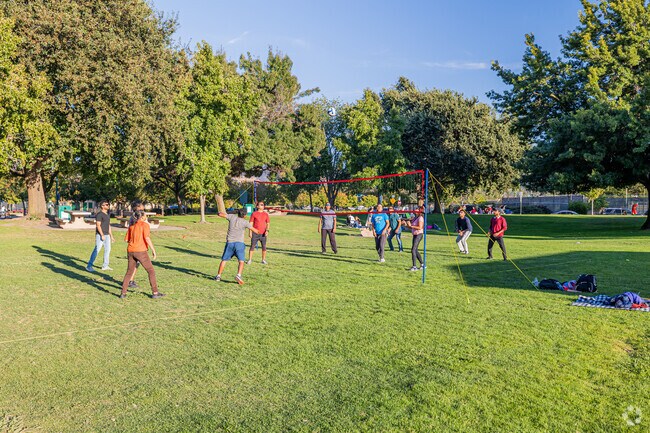 A group of friends play a pickup game of volleyball at Heather Farms Park.
