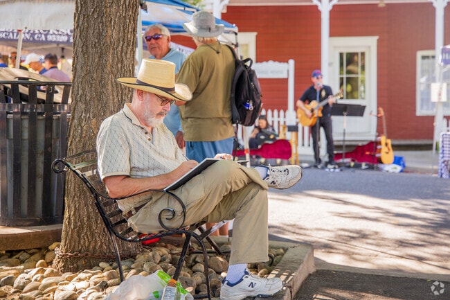 At the City of Sonora's Farmers Market, residents relax amidst the vibrant stalls, savoring the fresh produce and enjoying the lively atmosphere.