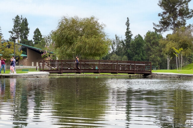 Visitors at Ralph B. Clark Regional Park can walk by the tranquil lake and play tennis.