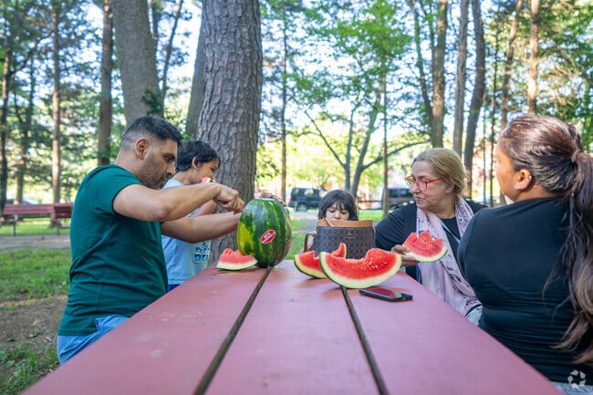 A Seven Corners family enjoys a watermelon at Munson Hill Park.