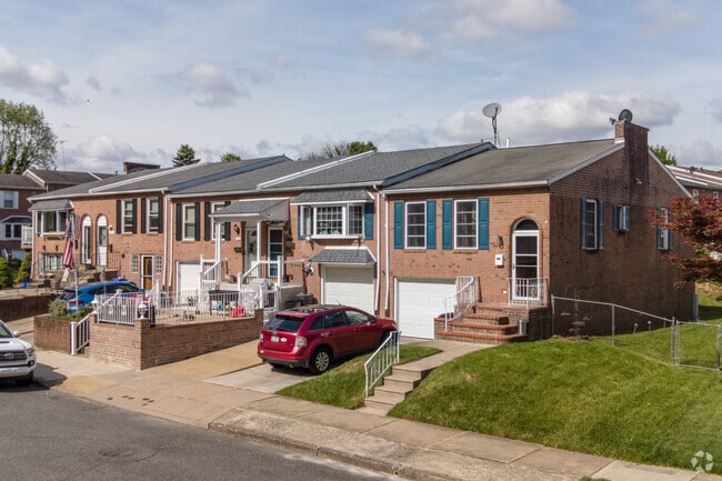 1 story brick row homes with attached garages nearby.