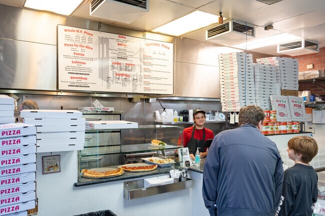 Locals enjoy a slice or dinner at Vinnie's Brooklyn Pizzeria.