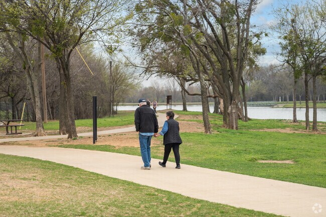 Burleson Residents strolling along pathway at Bailey Lake Park.