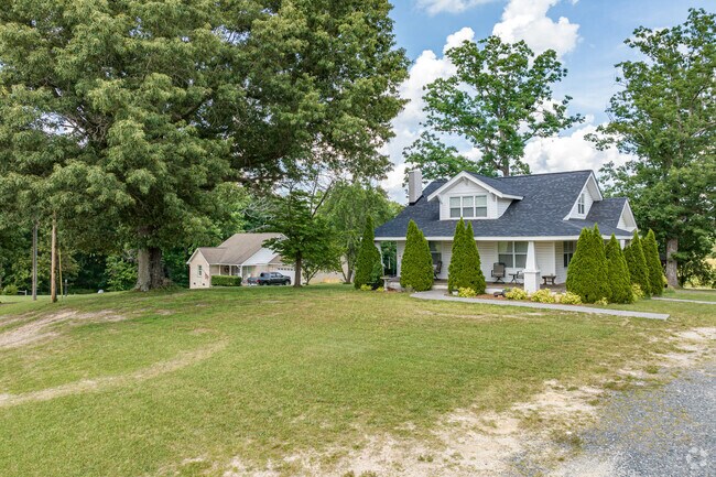 A craftsman-style home sits at the end of a gravel road in Frazier Marsh.
