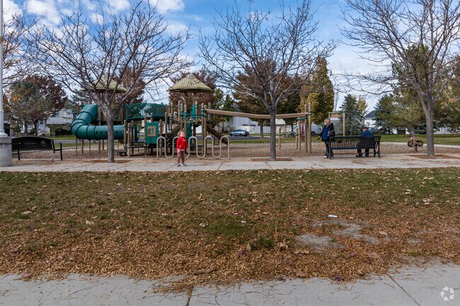 A child and his grandparents enjoy a beautiful fall day at Kingspointe Park.