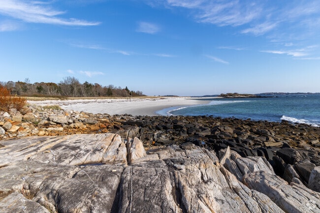 Rocky shores lead into white sands on Long Island.