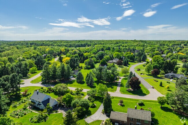 Lush residential streets curve through the rolling hills of Thurston.