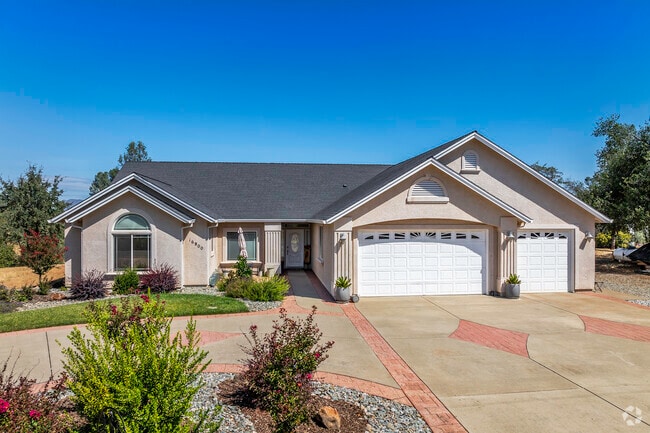 This more contemporary home has a 3-car garage and stucco siding in Happy Valley.