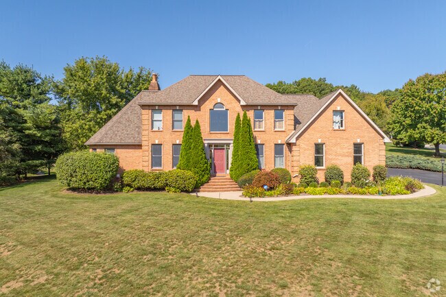 Large colonial revival estates sit sprawled on large lots, surrounded by trees.