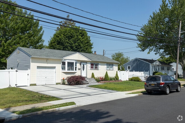 Many streets in Brentwood, NY have rows of ranch style homes on them.
