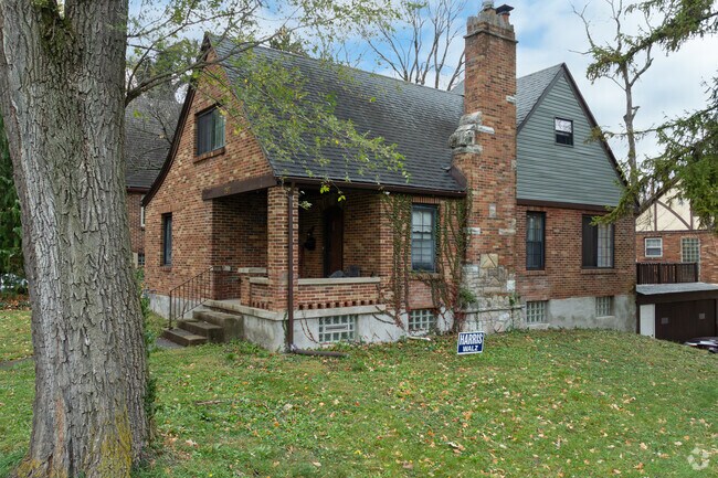 Tudor style homes are found in Fort McKinley with large trees around the area.
