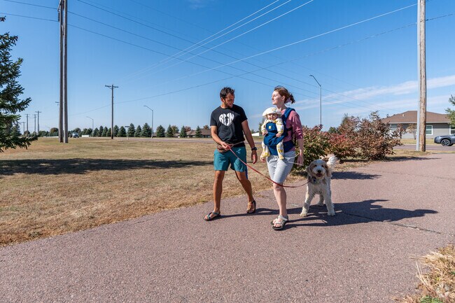 A family takes a stroll along one of the paths at Harmodon Park.