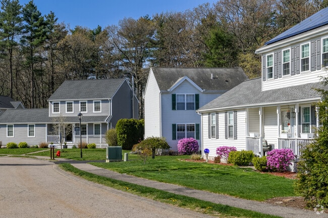 Newer developments in Millis include some with bright azalea bushes.
