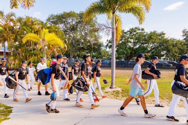 Young baseball players gather eagerly, ready to hit the field in Fort Pierce.
