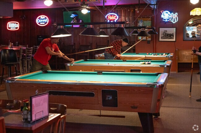 Enjoy a game of pool at one of the several bars in downtown Arbor Lodge.