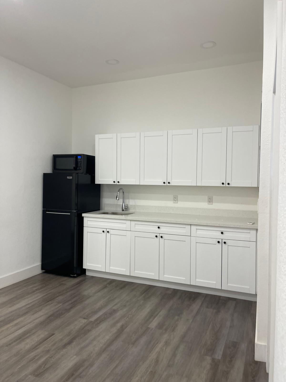 Kitchen with fridge, micro and storage space