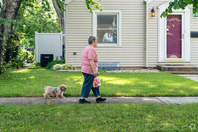 Marquette Park resident walks her dog on a warm summer day in Green Bay, Wisconsin.