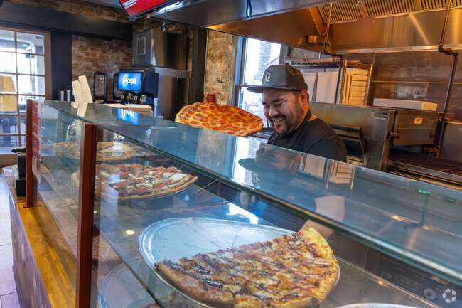 Grab a delicious slice of pizza at No Anchovies in North University.