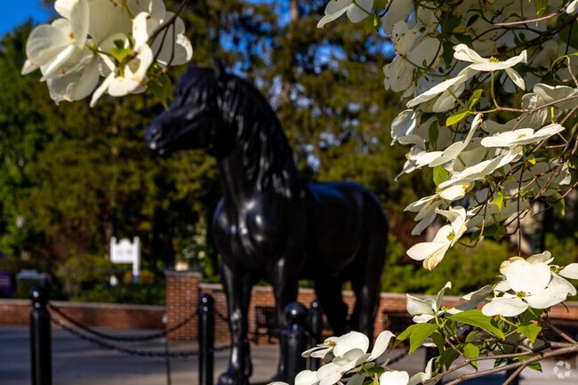 Percheron Statue surrounded by flowers to celebrate in Moorestown.