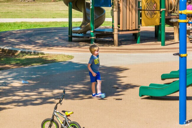 Kids can climb on the playground at Fox Run's Bluff Creek Park.