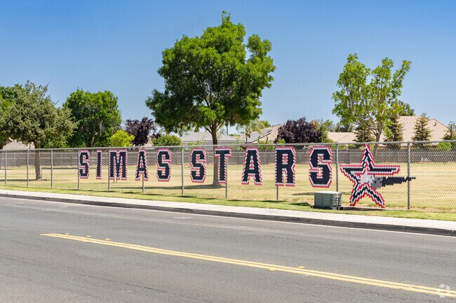 A large fence sign outside the entrance of Joseph M. Simas Elementary greets Hanford students.