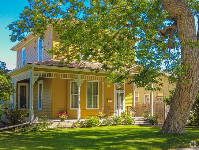 An outstanding yellow and white colonial inspired home in South Central neighborhood.