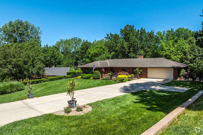 Many ranch homes are shaded by large mature trees in Platte Woods.