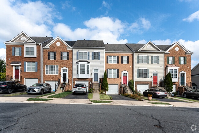 Townhomes with garages line Hildas Way in River Oaks, offering modern living.