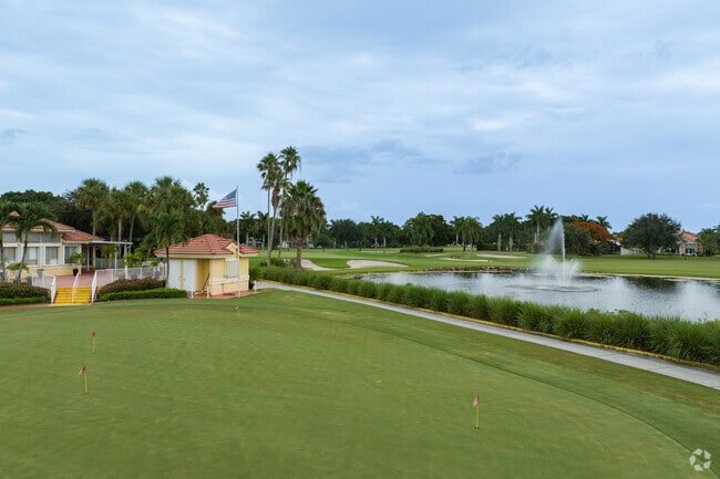 Atlantic National clubhouse overlooks a lake with a fountain.