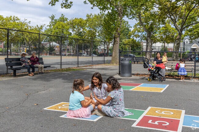 Children engage in traditional hand-games at Utopia Playground.