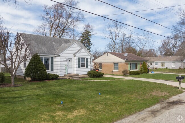Brick and siding single story cottage style homes are mixed throughout neighborhoods.